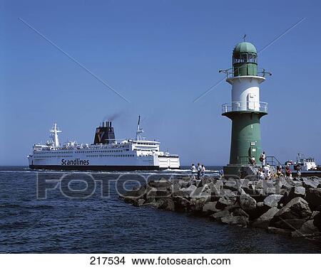 Tourists near lighthouse at coast, Rostock, Mecklenburg-West Pomerania, Germany View Large Photo Image Picture - Tourists near lighthouse at coast, Rostock, Mecklenburg-West Pomerania, Germany . Fotosearch