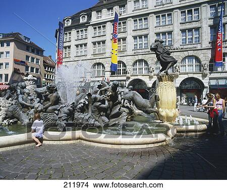 Tourists near sculptured fountain in city, Ehekarusell Fountain, Nuremberg, Bavaria, Germany View Large Photo Image Picture - Tourists near sculptured fountain in city, Ehekarusell Fountain, Nuremberg, Bavaria, Germany . Fotosearch
