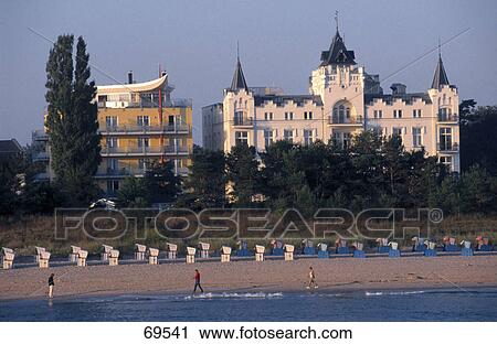 Stock Image - Tourists on beach, Palace Hotel, Zinnowitz, Usedom, Mecklenburg-Western Pomerania, Germany . Fotosearch