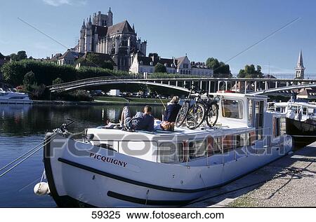 Tourists on boat in harbor, St Stephen's Cathedral and St Germain Abbey, Auxerre, Burgundy, France View Large Photo Image Stock Photography - Tourists on boat in harbor, St Stephen's Cathedral and St Germain Abbey, Auxerre, Burgundy, France . Fotosearch