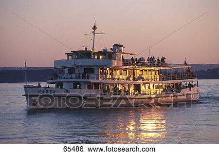 Stock Photograph - Tourists on boat in lake, Baden-Wuerttemberg, Germany . Fotosearch