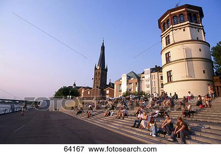 Tourists on steps at coast, Duesseldorf, North Rhine-Westphalia, Germany View Large Photo Image Stock Photo - Tourists on steps at coast, Duesseldorf, North Rhine-Westphalia, Germany . Fotosearch