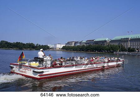 Stock Photograph - Tourists on tour boat in river, Alster River, Hamburg, Germany . Fotosearch