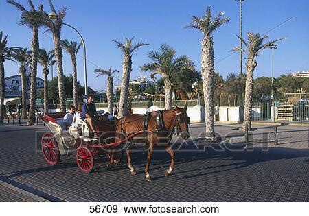 Tourists riding in horsedrawn carriage, Majorca, Balearic Islands, Spain View Large Photo Image Stock Photo - Tourists riding in horsedrawn carriage, Majorca, Balearic Islands, Spain . Fotosearch