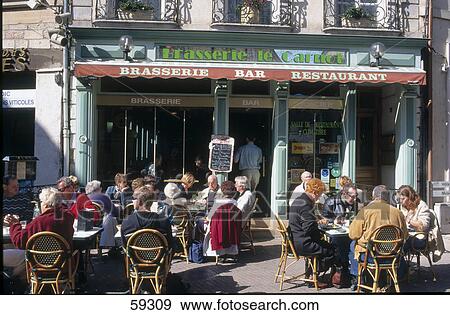 Tourists sitting at outdoor cafe, Beaune, Burgundy, France View Large Photo Image Stock Photo - Tourists sitting at outdoor cafe, Beaune, Burgundy, France . Fotosearch