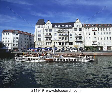 Stock Photo - Tourists traveling on tourboat in river, River Spree, Nicolaiviertel, Germany . Fotosearch