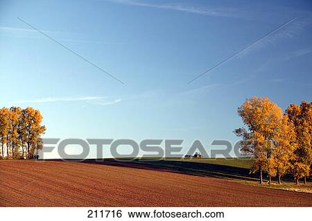 Stock Photograph - Tractor in field, Otzberg, Hesse, Germany . Fotosearch
