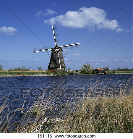 Stock Photography - Traditional windmill of riverside, Netherlands . Fotosearch