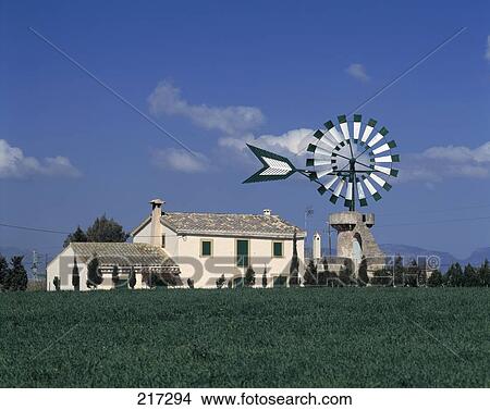 Picture - Traditional windmill on grassy landscape, Balearic Islands, Spain . Fotosearch