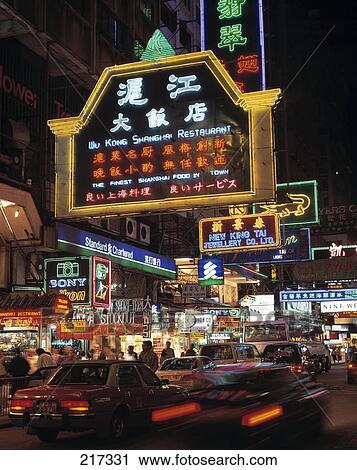 Stock Image - Traffic on road with neon lit up in background, China . Fotosearch