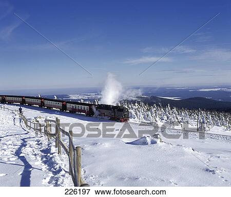 Stock Photo - Train traveling through snowcovered landscape, Germany . Fotosearch