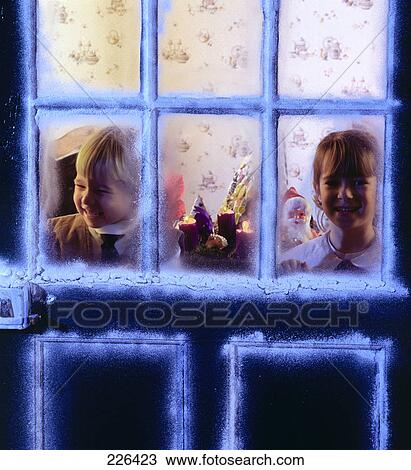 Two children behind door decorated with artificial snow View Large Photo Image Stock Image - Two children behind door decorated with artificial snow . Fotosearch