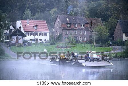 Stock Photography - Two people and car on boat in river, River Neckar, Heidelberg, Germany . Fotosearch