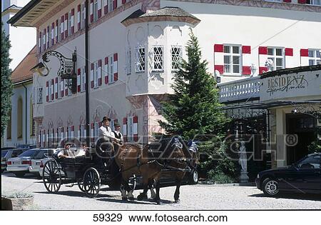 Stock Photo - Two people on horse drawn carriage, Aschau, Bavaria, Germany . Fotosearch
