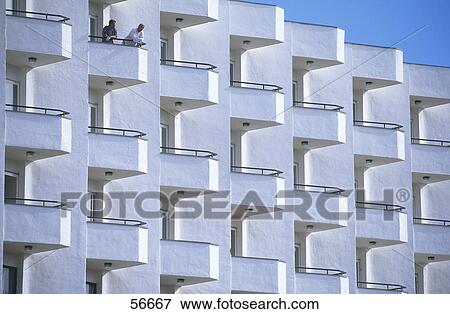 Two people standing on hotel balcony, Calas de Mallorca, Majorca, Balearic Islands, Spian View Large Photo Image Stock Photo - Two people standing on hotel balcony, Calas de Mallorca, Majorca, Balearic Islands, Spian . Fotosearch