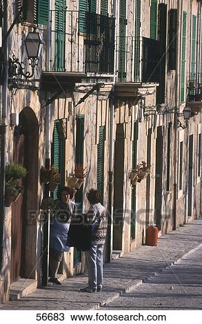 Two women talking in front of house, Valldemosa, Majorca, Balearic Islands, Spain View Large Photo Image Stock Image - Two women talking in front of house, Valldemosa, Majorca, Balearic Islands, Spain . Fotosearch