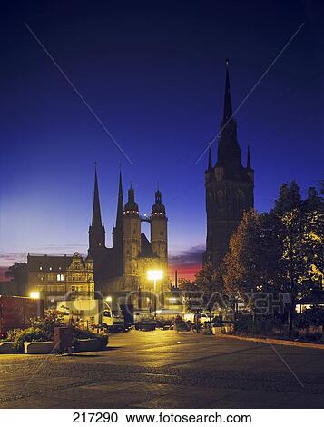 Stock Image - Vehicles in front of cathedral lit up at night . Fotosearch