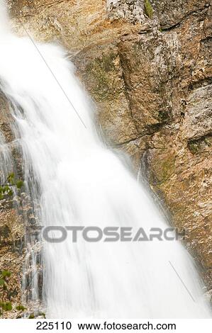 Stock Image - Waterfall in forest, Austria . Fotosearch