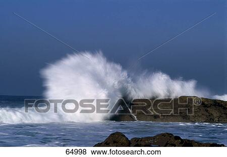 Waves breaking on rocks View Large Photo Image Stock Photo - Waves breaking on rocks . Fotosearch