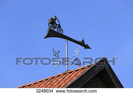 Picture - Weather vane on a roof top, Essen (Oldenburg), Germany, low angle view . Fotosearch