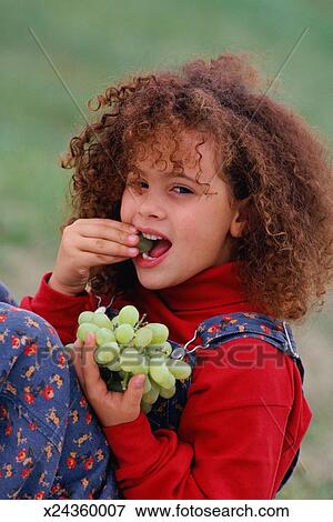 grapes eating girl fotosearch