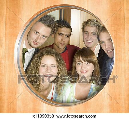 Group Of People Looking Through Window In Door Portrait Stock