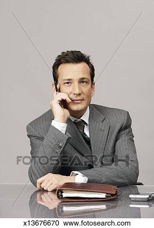 Business Man Sitting Behind Desk Portrait Studio Shot Stock