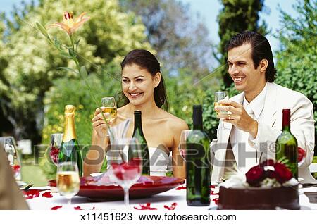 Newlywed Couple Raising A Toast At Their Wedding Reception Stock