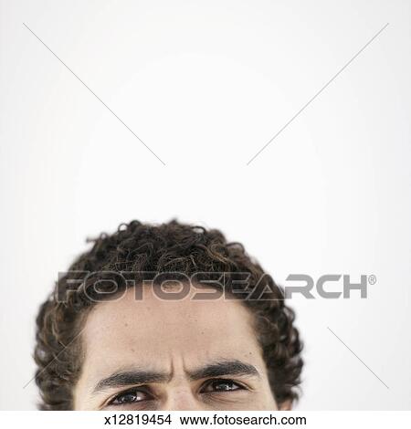 Top Of Head Of Young Man With Short Curly Brown Hair Against White