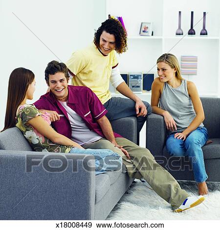 Four Young People Sitting On Sofa Relaxing Stock Photo X18008449