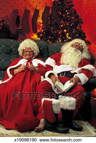 Portrait of Santa and Mrs.. Claus relaxing on the couch 