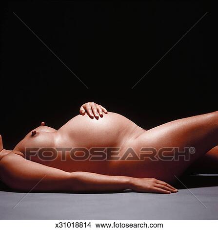 A Nude Pregnant Woman Lying Down On The Floor Picture X31018814