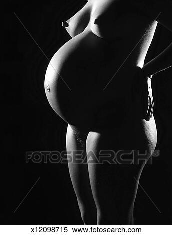 343px x 470px - A nude pregnant woman standing holding her hips (black and white) Stock  Photography