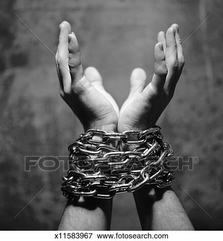 Picture of black and white close-up of wrists tied in chains x11583967