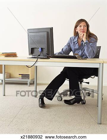 Stock Photo Of Woman Sitting At Office Desk Looking Away From Stock Photo Woman Sitting At Office Desk Looking Away From Computer Monitor Fotosearch