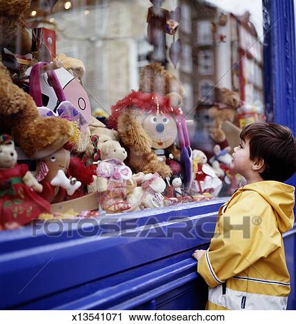 boy-3-5-looking-at-toys-in-shop-stock-im