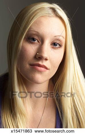 A Teenage Caucasian Girl With Long Straight Blond Hair Has A