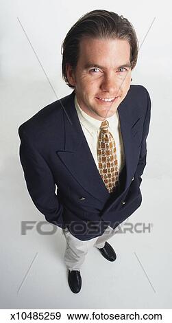 A Handsome Young Caucasian Man With Long Dark Hair Dressed In A