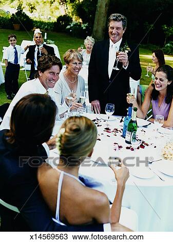 Father Giving A Speech To The Bride And Groom At A Wedding