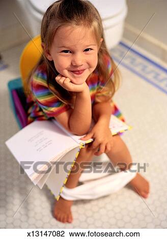 Girl Reading A Book On A Potty Chair Stock Image X13147082