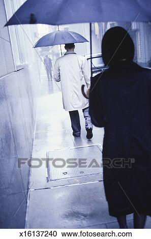 People Walking In Rain On Street Rear View Stock Image