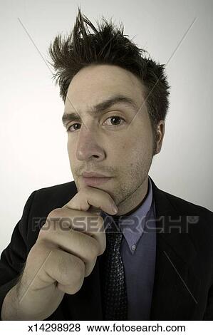 Man With Spiky Hair Posing In Studio Holding Chin Portrait Stock