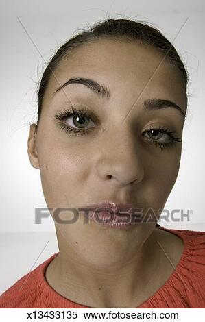 Young Woman With Hair Tied Back Posing In Studio Portrait Stock