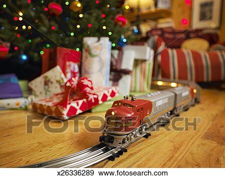 toy train around christmas tree