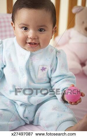 Baby Girl 9 12 Months Playing With Ball In Crib Portrait Stock