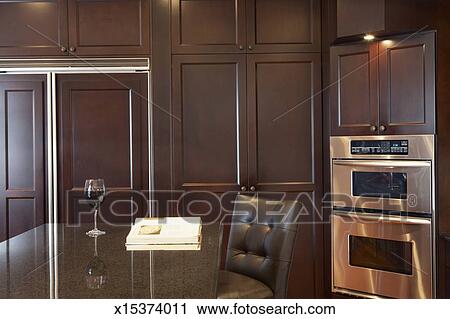 Kitchen With Granite Countertops Wooden Cabinets And A Stainless