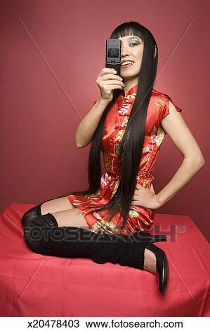 Young woman with long hair in Chinese dress and knee-length stockings