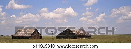 Old Barns With Rusty Metal Roofs In Open Field Stock Image