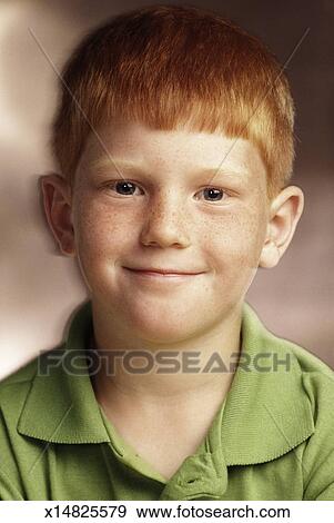 Happy Young Boy With Red Hair And Freckles Wearing A Lime Green