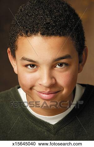 Studio Portrait Of An African American Male Teen As He Smiles